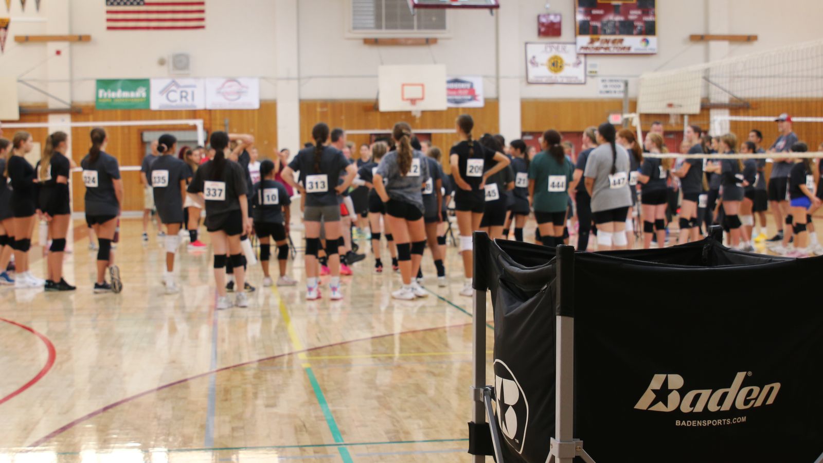 Players wearing numbered tryout jerseys gathered on the court at Aftershock tryouts