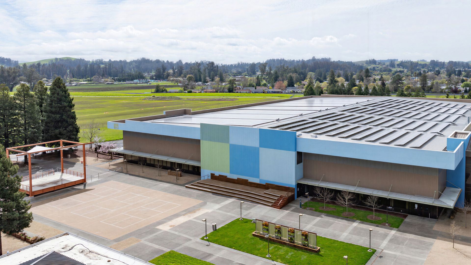 RallyHouse at SOMO Village in Rohnert Park, seen from above, with solar panels across its roof and a wide plaza in front